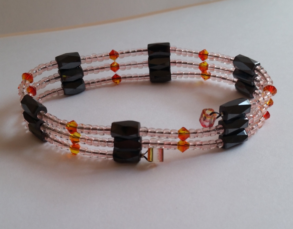Wrap bracelet for women is about 22 inches long. There are 2 strawberry-lemon square beads, 18 faceted magnetic hematite beads (black), 17 fire opal Swarovski beads (orange, yellow), and 170 glow in the dark pink seed beads (glows green).