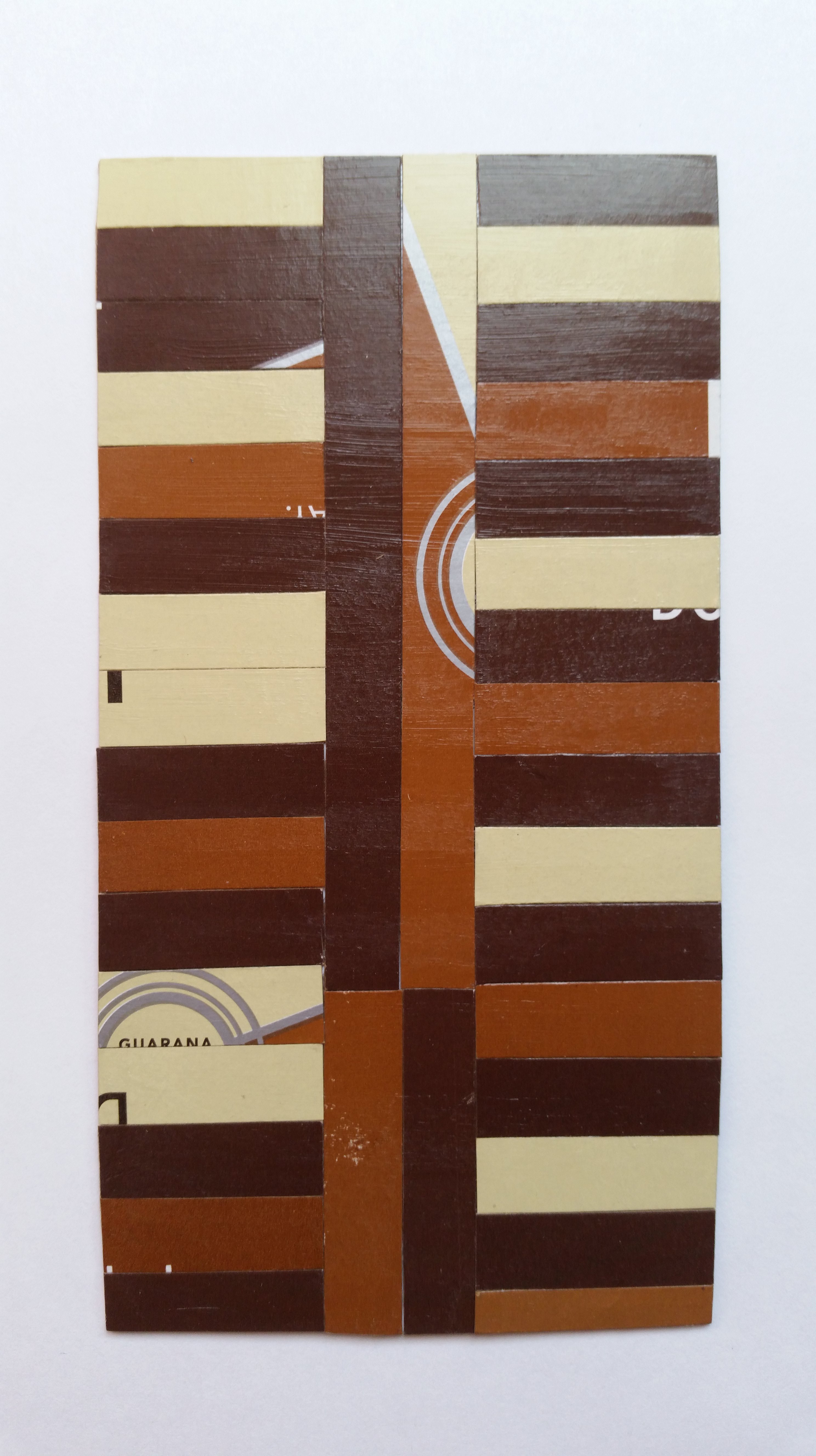 Card has Coffee pattern. Card has strips of the box glued vertically in the middle with shorter strips glued horizontally on either side of the vertical strips. Brown, dark brown, beige, and some silver and white detail.